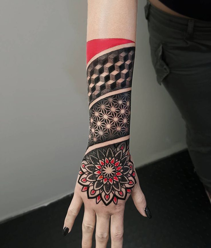un tatouage femme avant bras graphique à motif fleur de la vie en rouge et noir