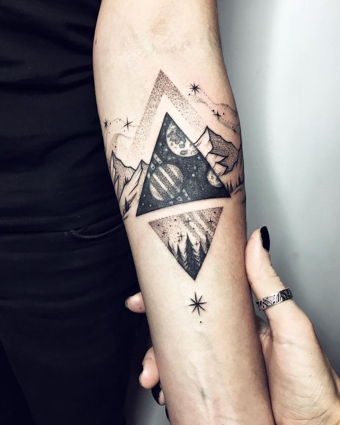 un tatouage geometrique représentant la terre et le cosmos dans deux triangles opposés
