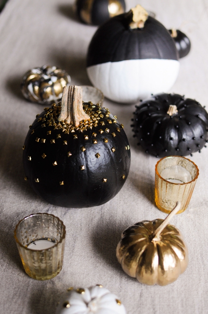 modele citrouille halloween, décoration simple avec récipient en verre et bougies blanches, petite citrouille noire avec perles noires