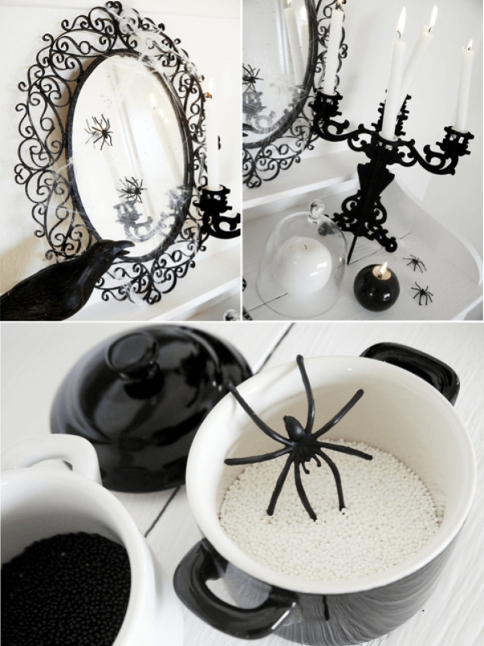 déco halloween en blanc et noir, miroir ovale en style baroque avec petites araignées décoratives et bougeoir blanc et noir