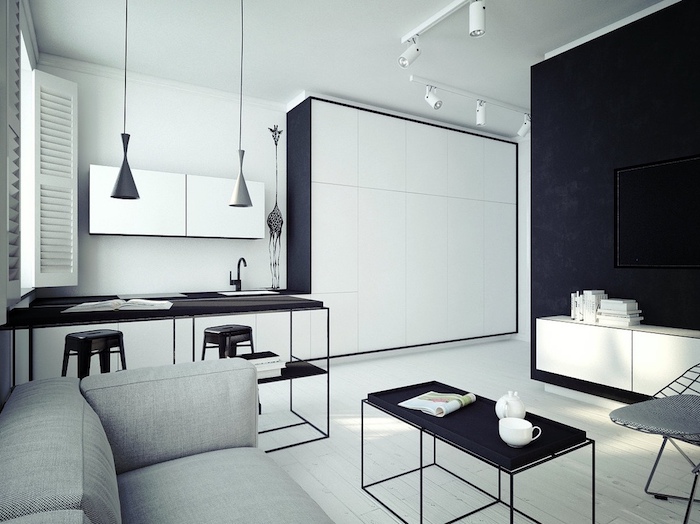 comment aménager une cuisine en longueur en blanc et noir, bar et chaises en metal, salon avec canapé gris, table basse minimaliste noire