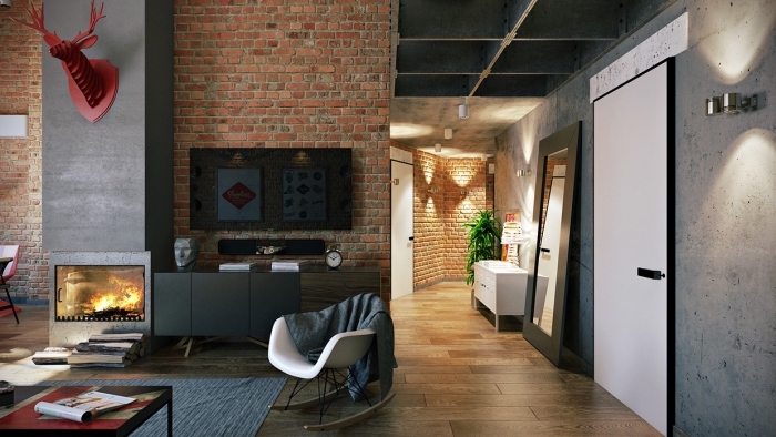 déco de chambre loft en style industriel avec cernes décoratives rouges, cheminée moderne en gris et murs en briques rouges