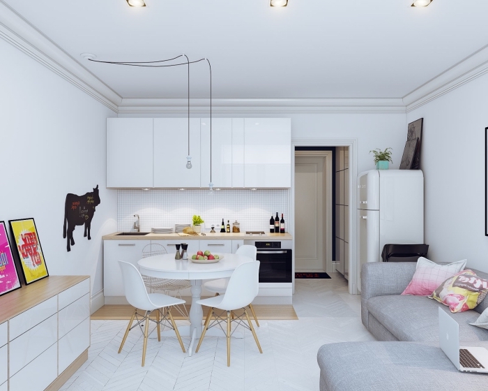 modele de cuisine, meubles de cuisine en blanc et bois sans poignées, canapé d'angle gris avec coussins rose et jaune
