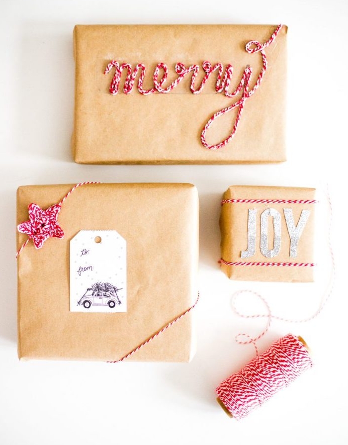emballer cadeau, idée de boites enveloppées de papier kraft avec décoration en fils rouge et blanc, motif fleur et le mot joyeux 
