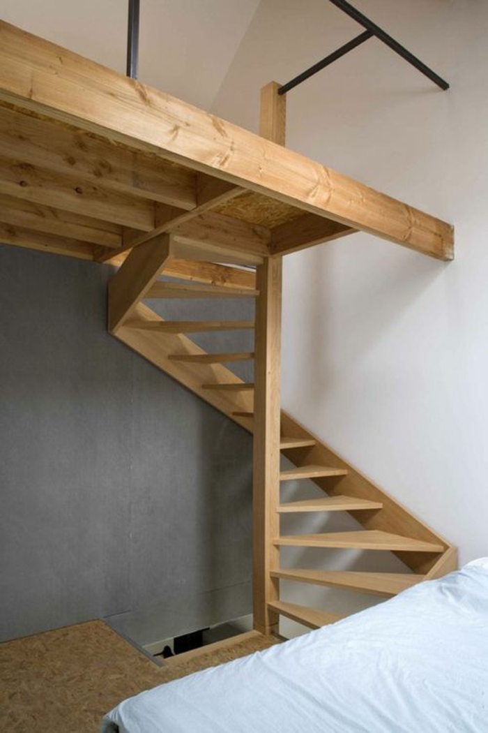 escalier design en bois clair, avec des marches fines et larges qui se déploient en forme angulaire, maisonnette avec les murs en blanc et gris 
