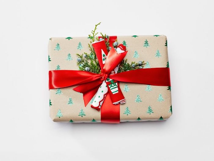idée de paquet cadeau noel en papier kraft à motifs sapin de noel vert, ruban rouge et branches vertes
