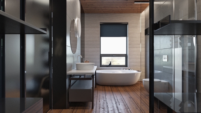 revetement de sol salle de bain, miroir rond sur mur au carrelage blanc, paroi de bains en verre et plancher en bois