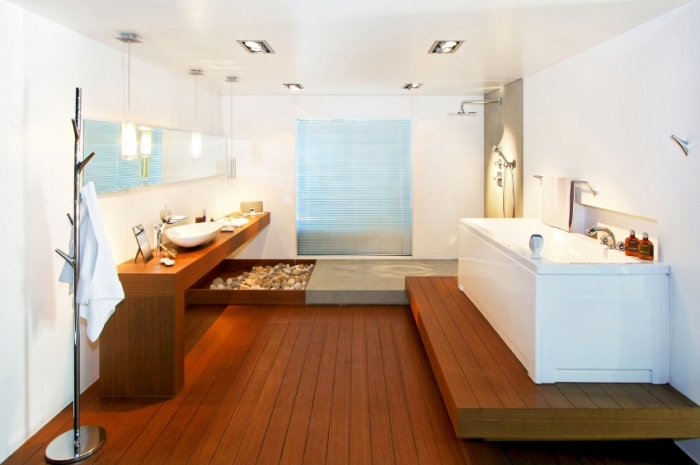 amenagement salle de bain, ambiance zen avec galets, meubles et plancher en bois foncé avec murs et plafond blanc