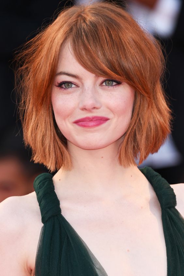coupe cheveux courts avec des cheveux rouges, l'actrice Emma Stone avec raie latérale, look pour le tapis rouge d'un festival de films 