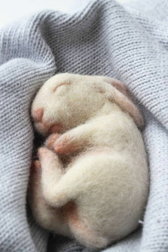 bricolage avec laine blanche, un petit lapin réalistique, lapin qui dort