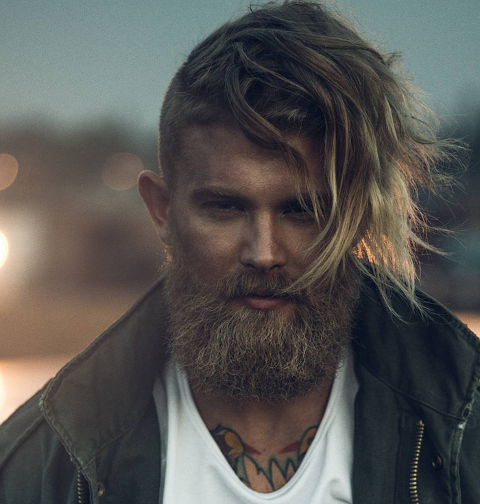 hipster viking avec barbe taillée et cheveux longs blonds cotés courts