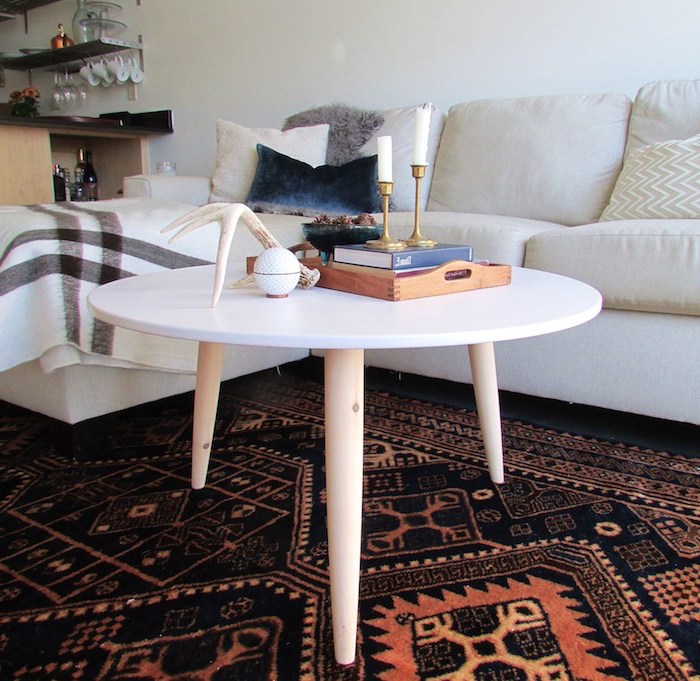 table basse diy en bois avec plateau rond blanc et pieds de bois, tapis oriental orange et noir, canapé blanc