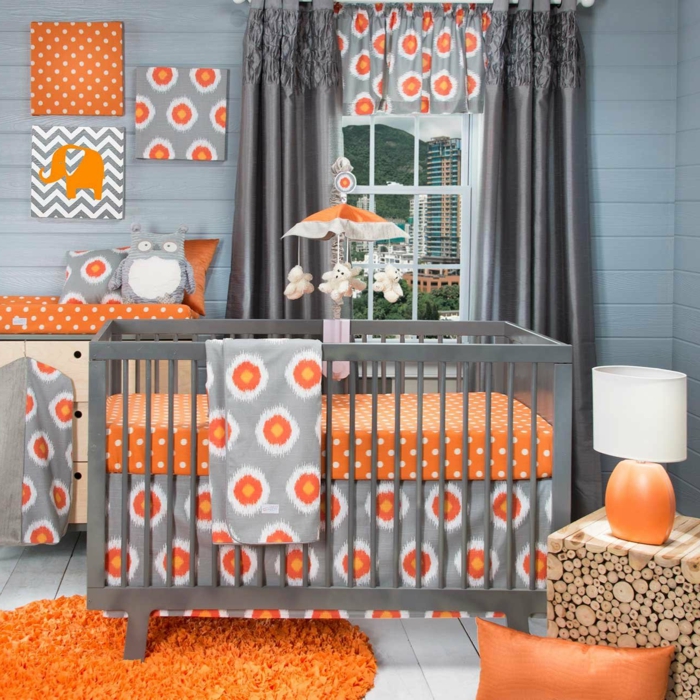 idée déco chambre bébé mixte, tapis rond, coussin en cuir orange, papier peint original
