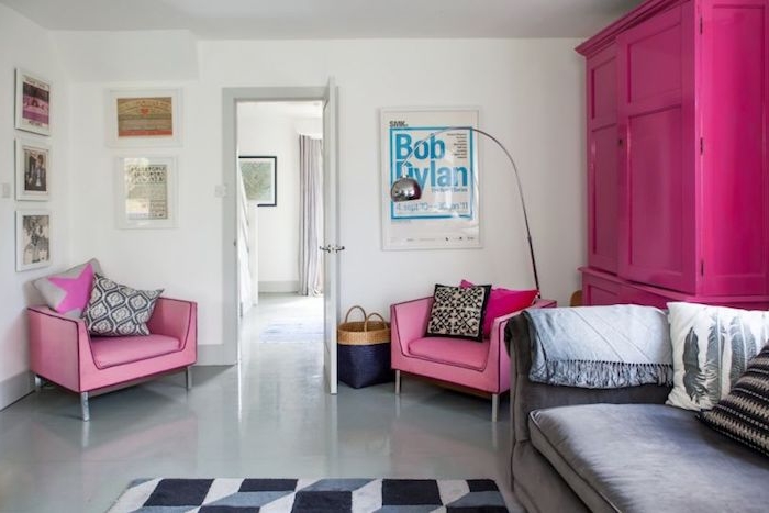 canapé couleur taupe clair, armoire fuchsia et fauteuils rose, sol gris clair, deco murale de cadres