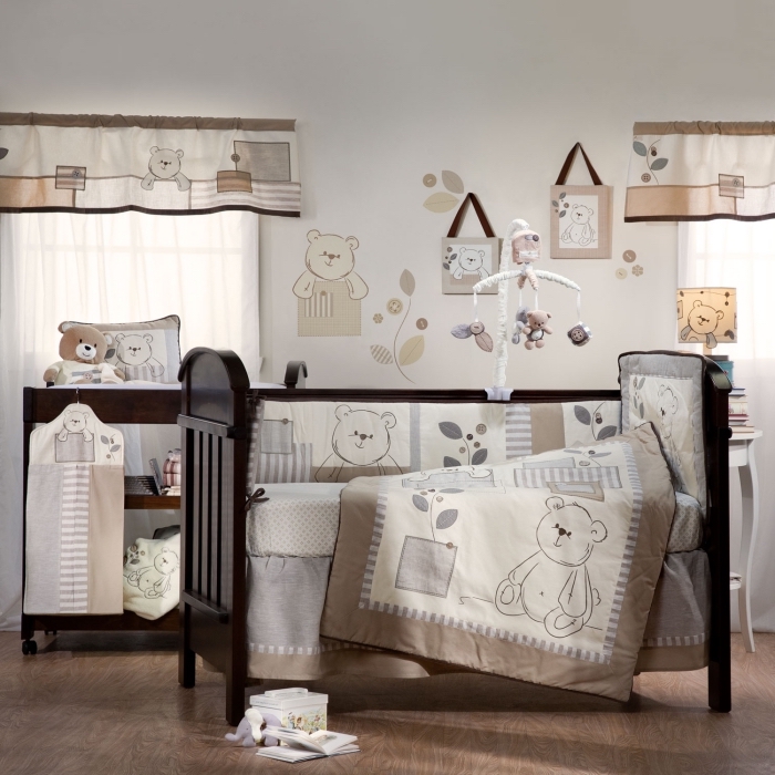 couleurs neutres dans la chambre bébé mixte avec plancher de bois et lit à barreaux noir, décoration des murs avec dessins et stickers à design ourson