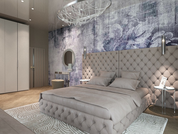 grande tête de lit en deux parties capitonnées, mur bleu, petite coiffeuse avec miroir et tabouret beige