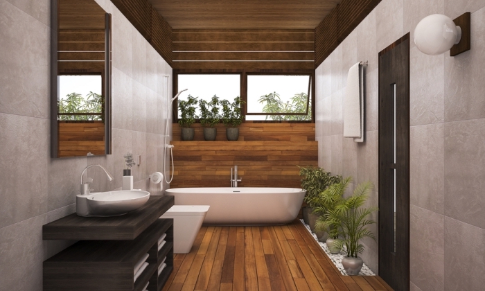 meuble salle de bain bois foncé, revêtement mural en carrelage beige avec pan en bois marron, plantes vertes pour ambiance relaxante