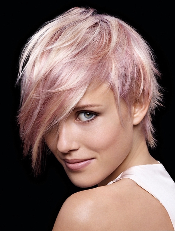 mèches rose pastel sur cheveux blonds courts avec frange hyper longue effilée à porter sur le côté pour un look déstructuré