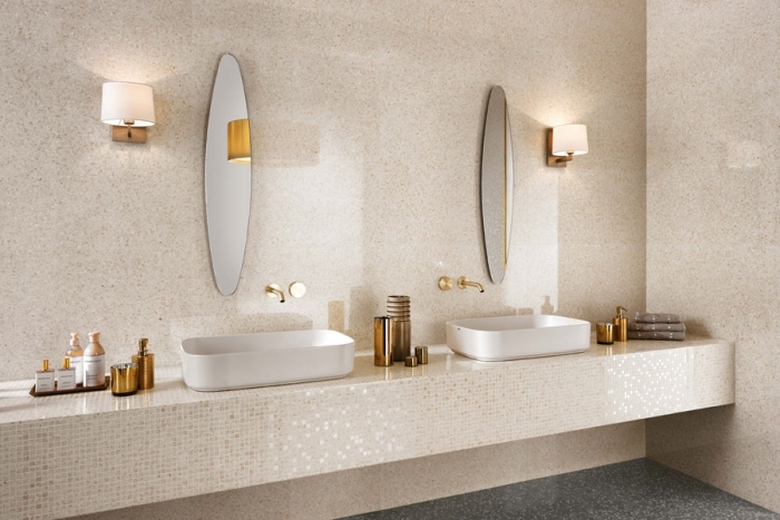 deco salle de bain en nuances beige et blanche, revêtement mural en carrelage beige, modèle de miroir oval et accessoires de bains cuivrés