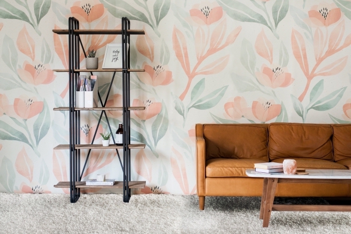 déco de salon avec canapé de cuir camel et table basse en bois et marbre, modèle de papier peint aux motifs floraux de nuances pastel