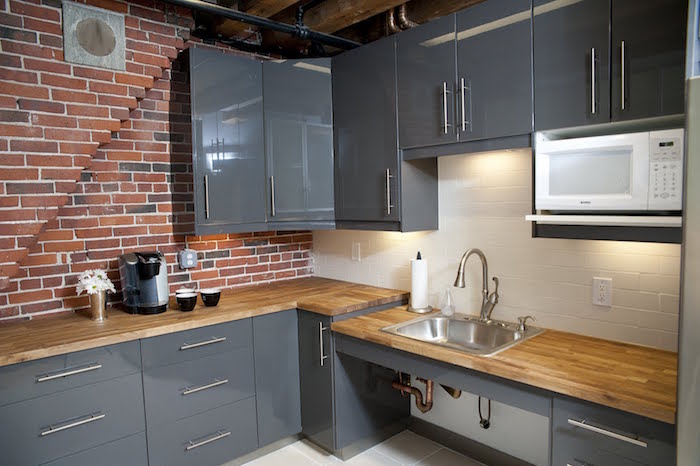 cuisine gris laqué moderne, intérieur avec mur en brique, décoration industrielle pour cuisines aménagées
