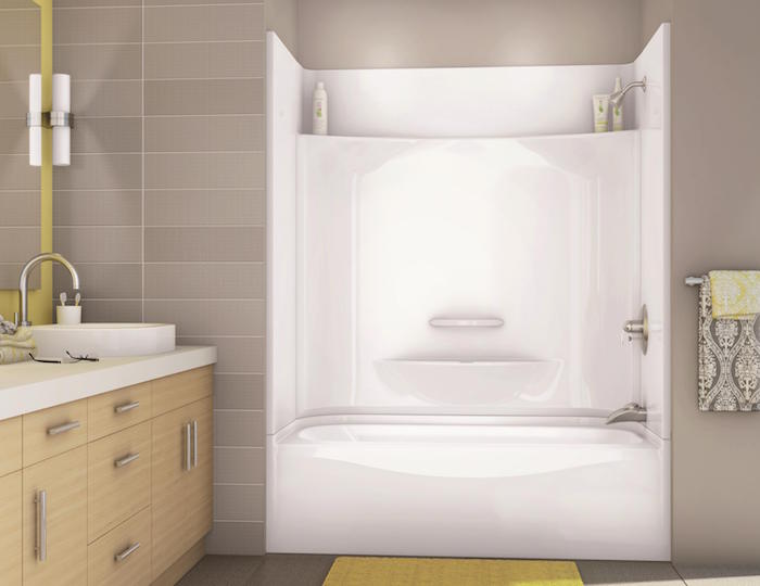 salle de bain avec baignoire encastrée dans mur beige taupe clair et carrelage mural gris clair
