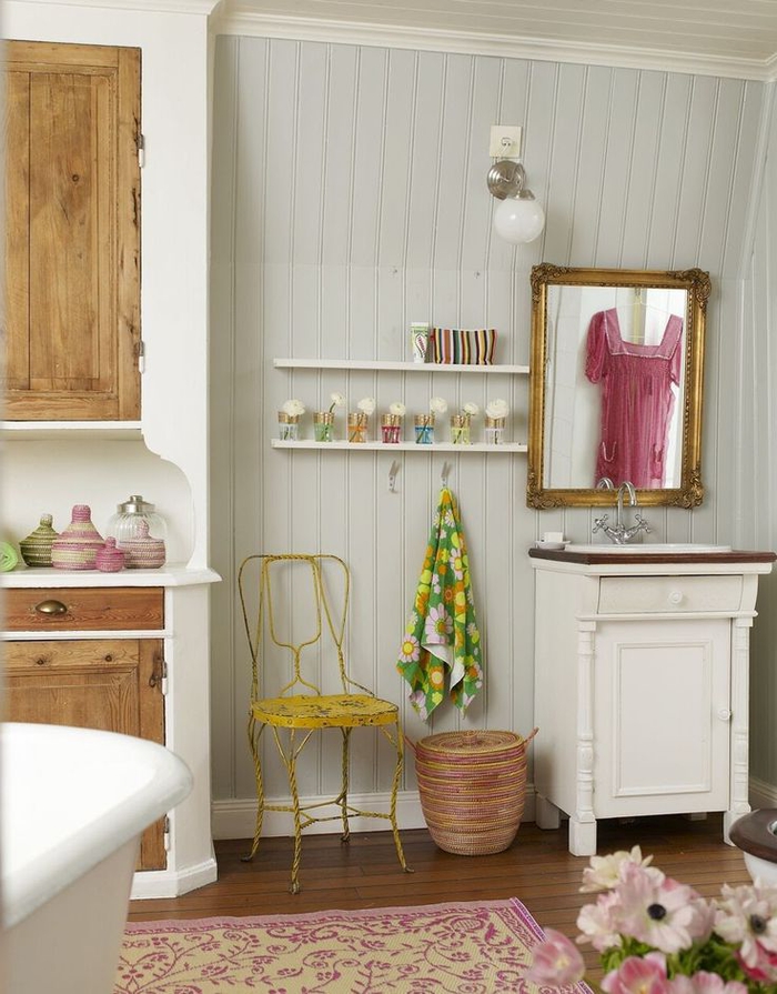 salle de bain ancienne au lambris de bois et aux touches colorées avec un coin vasque vintage 