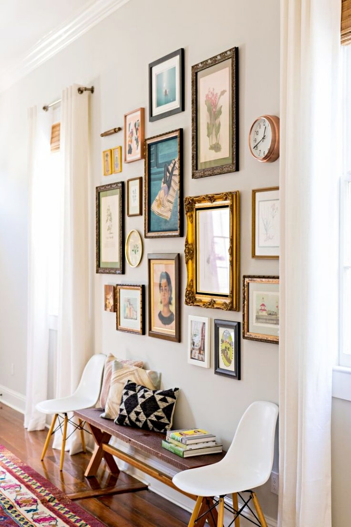 quelle couleur pour agrandir un couloir aux murs blancs avec déco de cadres photos, petit banc de bois et chaises basses