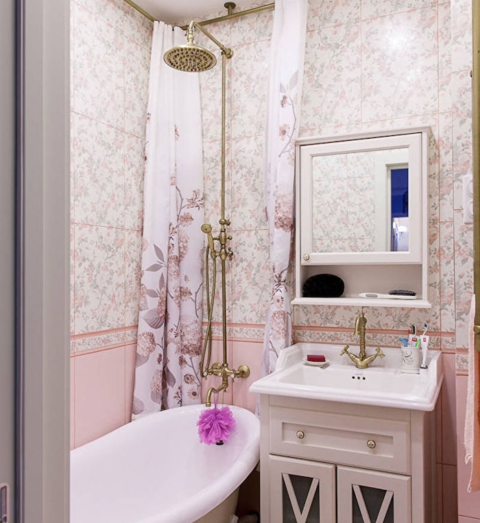 agencement salle de bain shabby chic avec carrelage à imprimé floral et rose, baignoire à poser, douche dorée, meuble haut avec miroir, meuble sous vasque blanc