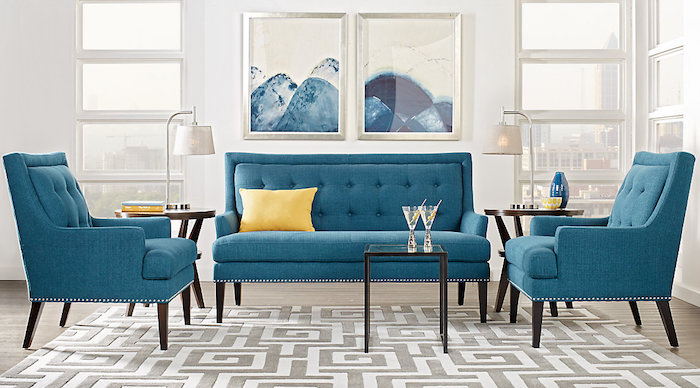 ensemble canapé fauteuils retro couleur bleu paon sur tapis tapis gris et murs blancs