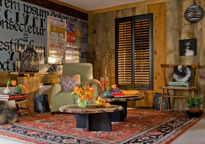 salon splendide style boho chic, deux tables en bois authentique, art monochrome, fauteuil beige, grand tapis persan