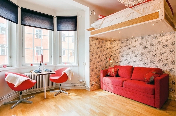 optimisation de l'espace dans un petit studio étudiant avec meubles escamotables, déco chaleureuse en bois et rouge