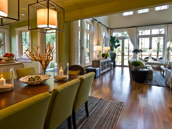 cuisine ouverte sur salon, chaises vertes, tapis rayé, sol en bois, équipement salon moderne, lampes pendantes tendance