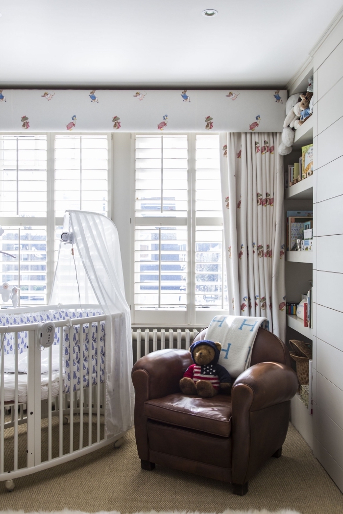 aménagement de chambre bébé avec bibliothèque encastrée et grand fauteuil de cuir marron, modèle de lit bébé avec baldaquin