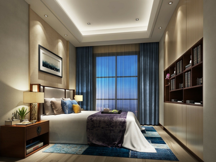 tapis bleu et bibliothèque intégrée dans une chambre feng shui, rideaux bleus