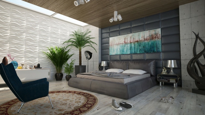 lit et tête de lit gris, chaise noire, tapis rond, sol en planches de bois, revêtement mural panneaux blancs