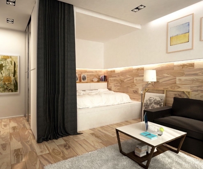 exemple comment séparer la chambre à coucher dans un studio avec rail de rideaux, intérieur moderne aux murs blancs et revêtement partiel en bois