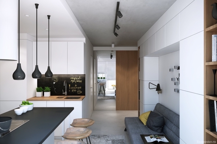 intérieur moderne dans un petit studio avec petite cuisine en blanc et bois, modèle d'éclairage industriel à finition noir