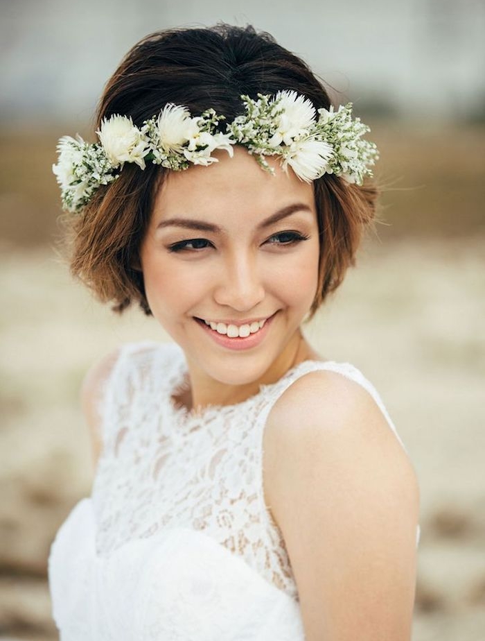 bout de cheveux chatain clair sur cheveux à racines chatain foncé avec couronne de fleurs blanches, robe de mariée dentelle, coiffure mariage boheme