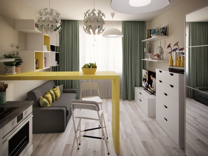 intégrer des couleurs vibrantes dans la déco monotone, studio moderne avec petite cuisine équipée d'un ilot central jaune
