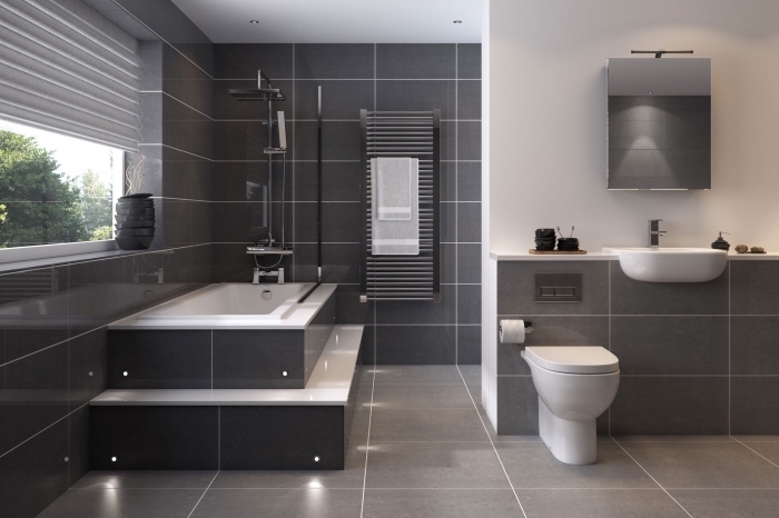 modèle de salle de bain moderne avec murs en revêtement carrelage gris et plafond blanc avec éclairage led