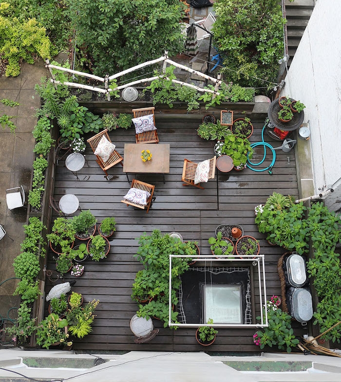 exemple d idée terrasse bois composite en table et chaises bois et plusieurs plantes en pots