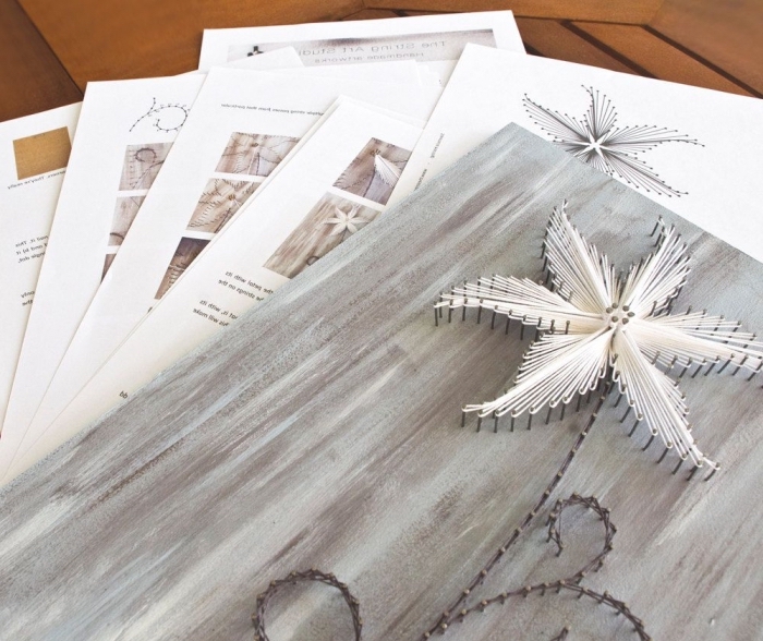 essayer une activité manuelle facile avec un kit de création fil à coudre en forme de fleurs sur une planche de bois