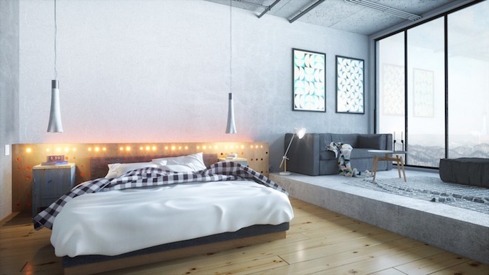 idée de tête de lit en bois et lit bois avec linge de lit noir et blanc, parquet clair, lumières intégrées, estrade salon gris dans un studio loft industriel