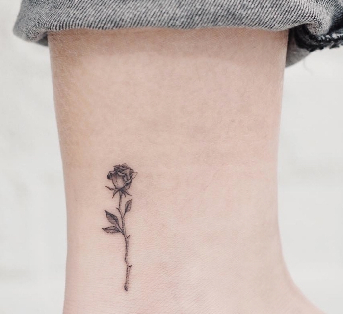 exemple d'art corporel dans l'esprit minimaliste avec un dessin aux motifs floraux, petite rose tatouée sur la cheville