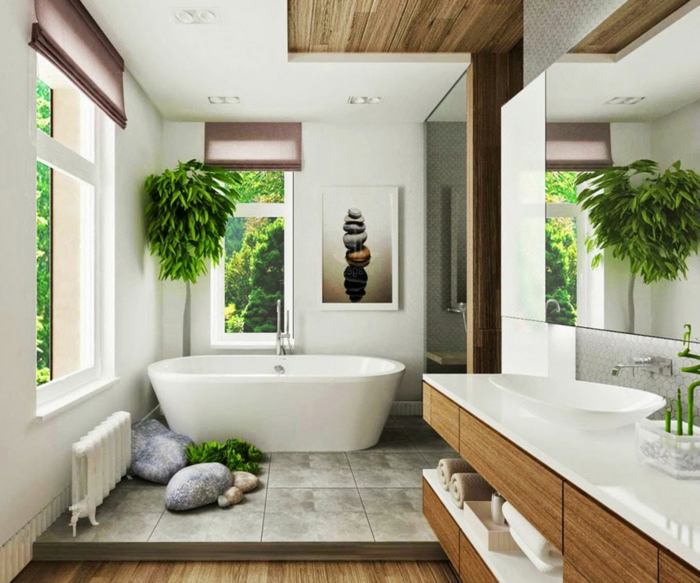salle de bain en deux niveaux, dalles grises et parquet en pvc synthétique, baignoire blanche ovale, lavabo ovale blanc, arbre dans un coin, plantes d'appartement