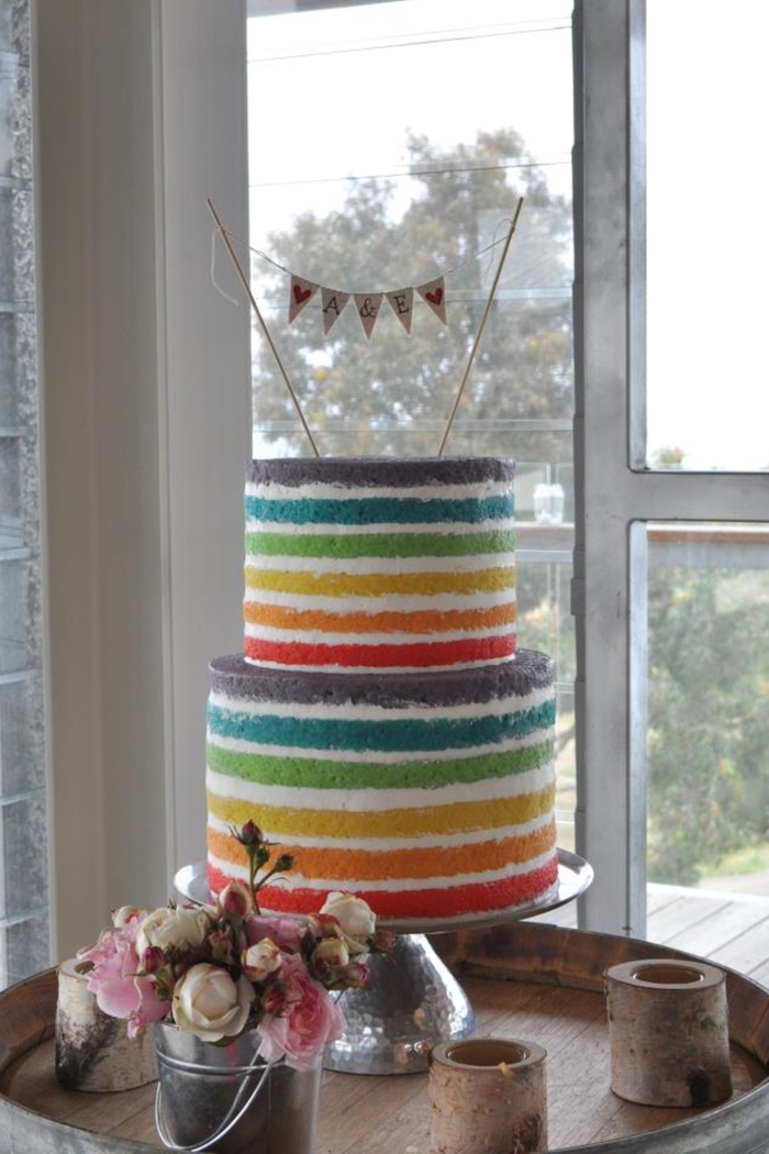 recette de wedding cake arc-en-ciel à deux étages, à la crème chantilly sans glaçage sur les côtés idéal pour un mariage champêtre