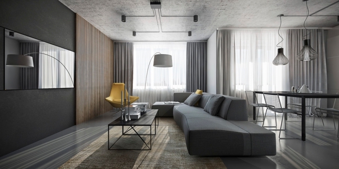 exemple de déco moderne dans un salon en gris foncé avec tapis beige et pan de mur en bois marron, modèle de chaise fauteuil jaune