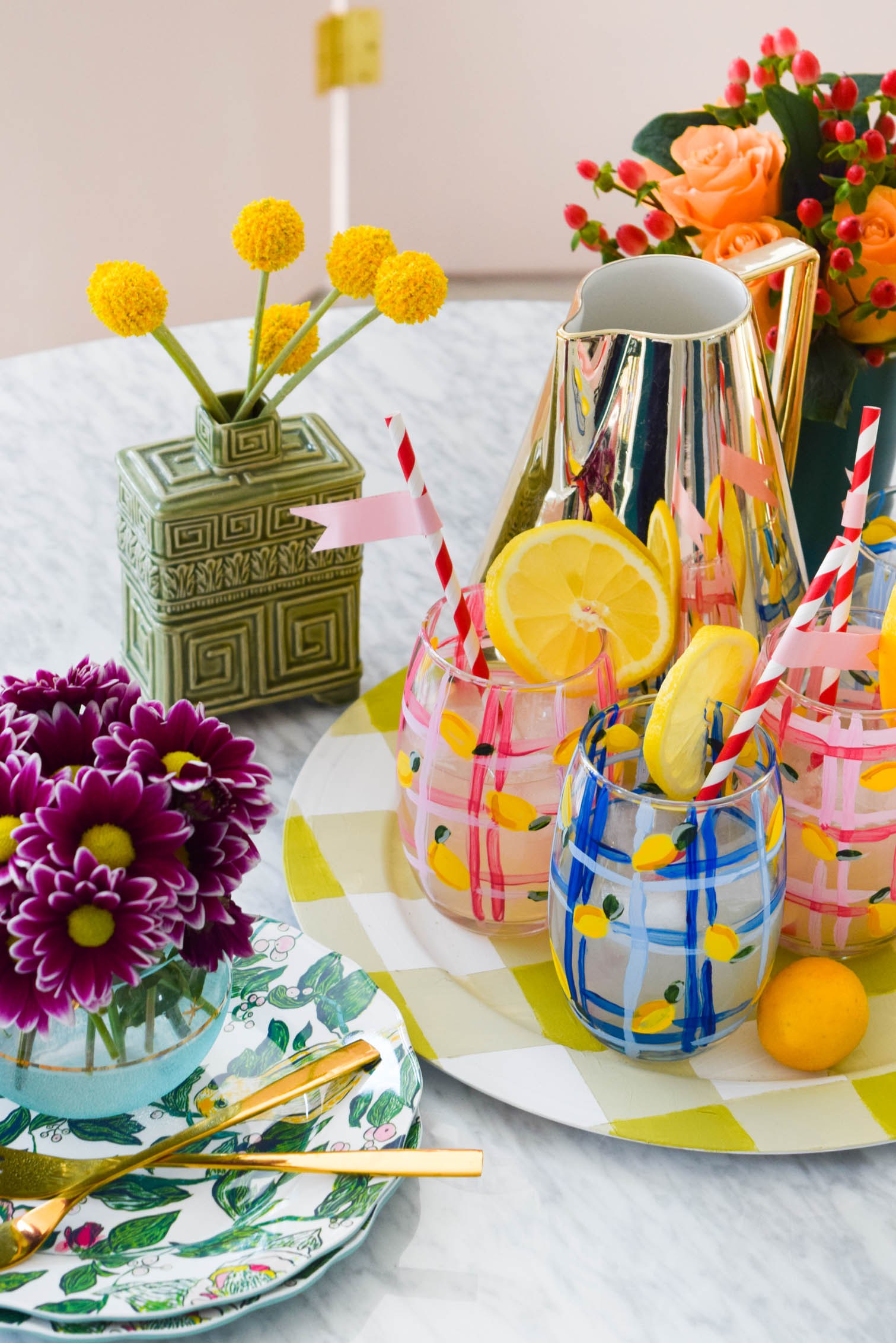 activité manuelle été, verre décoré de motif citron jaune et des bandes bleues et rose dans un plateau de service, bouquet de fleurs