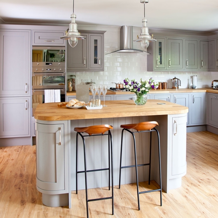 modèle de déco campagne dans une cuisine avec parquet de bois équipée de meubles bois peints en couleur pastel